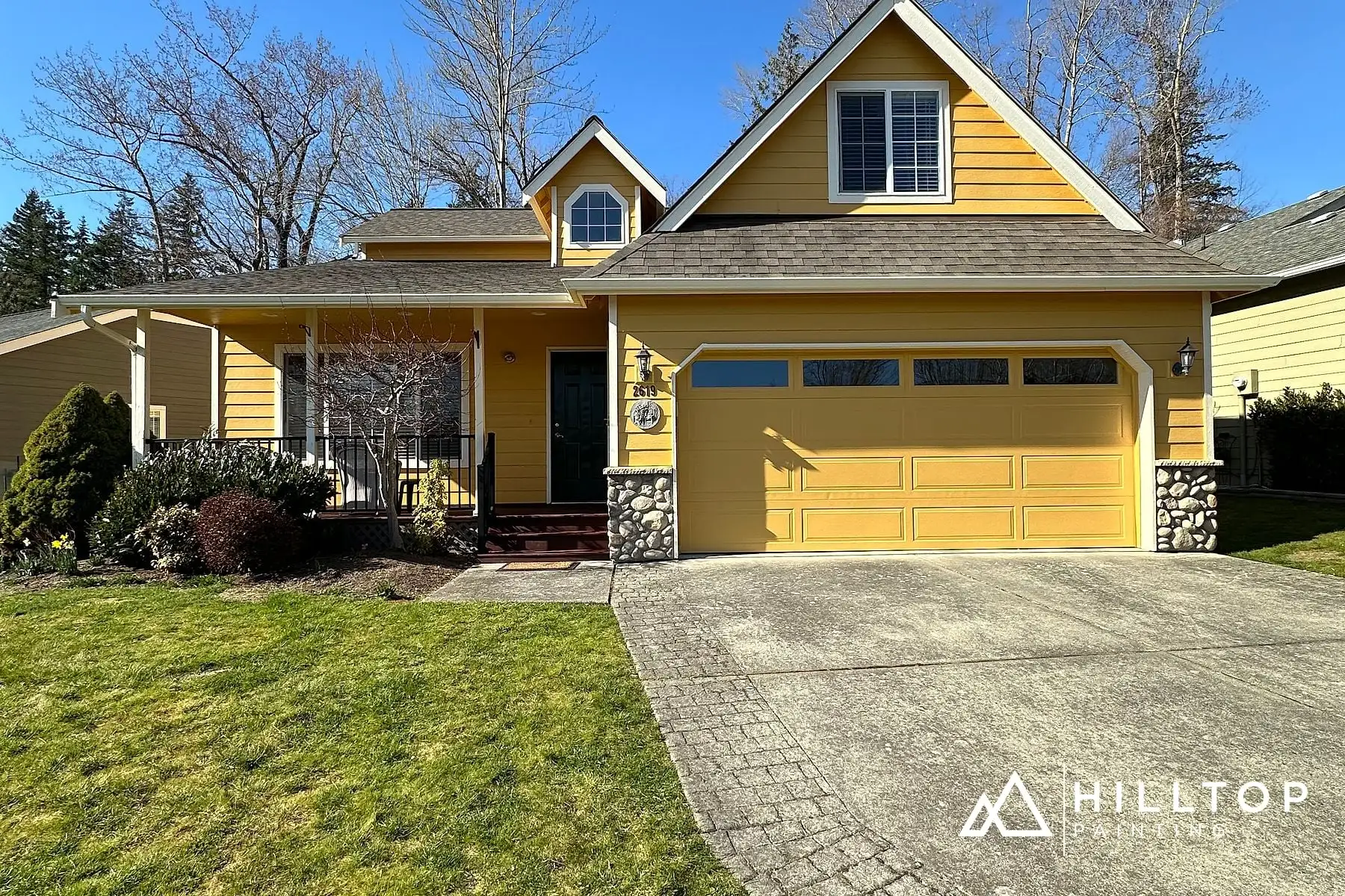Butter-Yellow Kept Warm — a Bellingham Stone-Front Cottage & Its Garage Doors